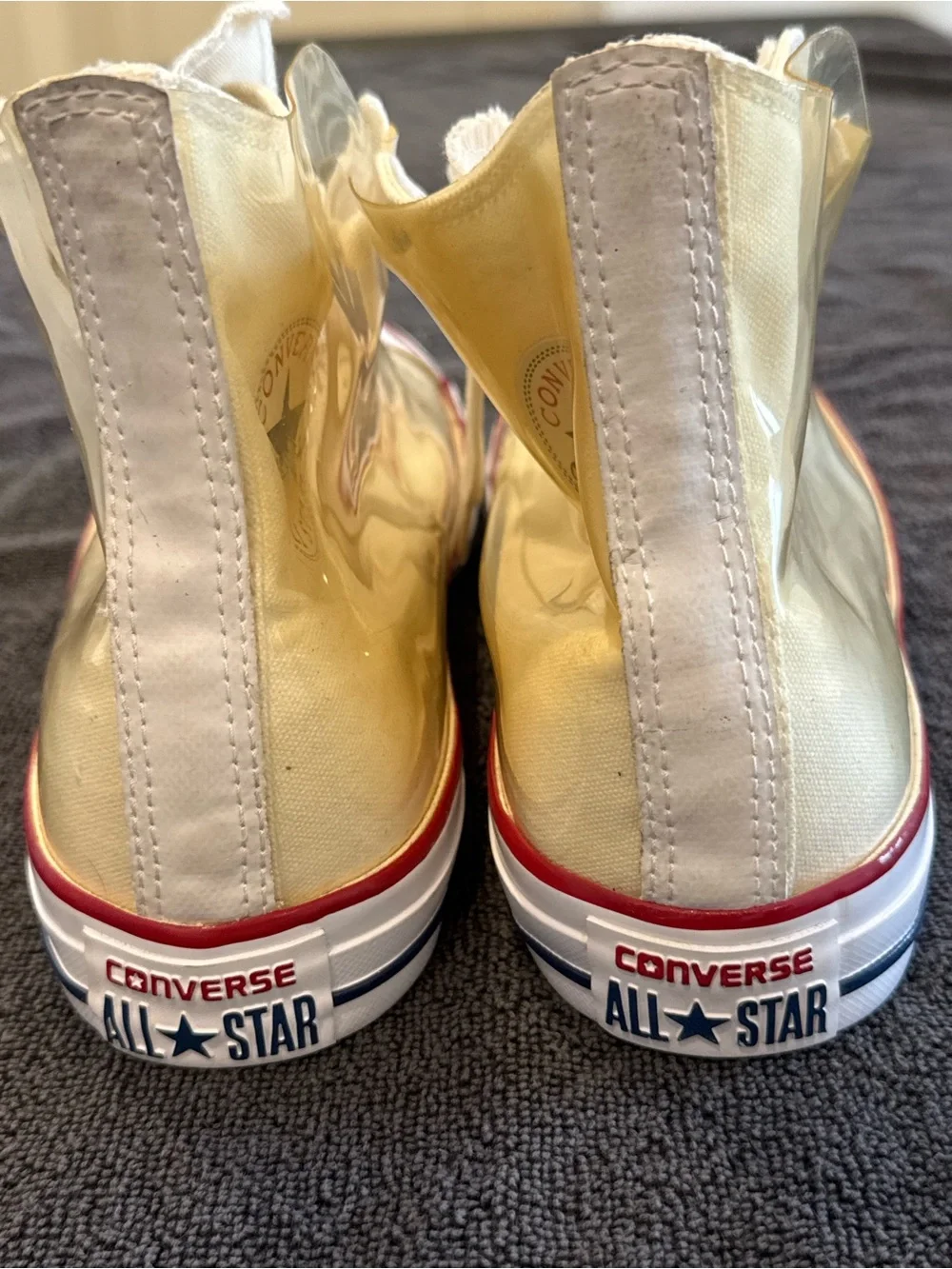 Converse white High Top Sneakers with vinyl zip cover.